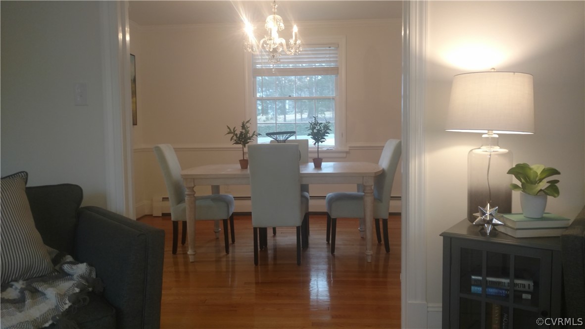8316 Abbey Road Richmond, VA 23235 - Photo 2 of 15 a view of a dining room with furniture window and wooden floor