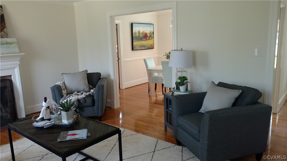 8316 Abbey Road Richmond, VA 23235 - Photo 3 of 15 a living room with furniture rug and wooden floor