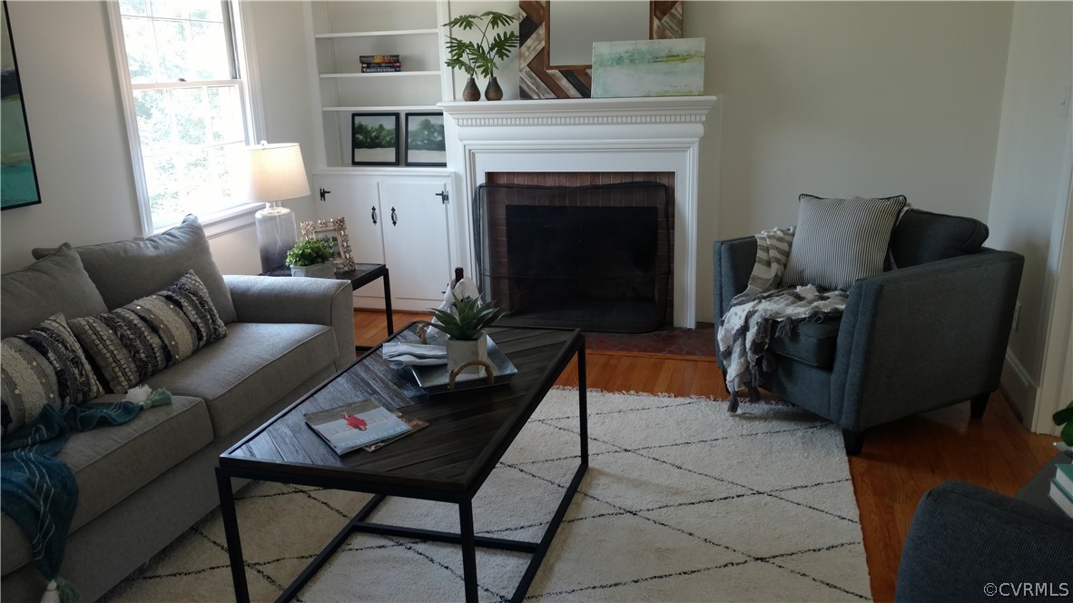 8316 Abbey Road Richmond, VA 23235 - Photo 4 of 15 a living room with furniture and a fireplace