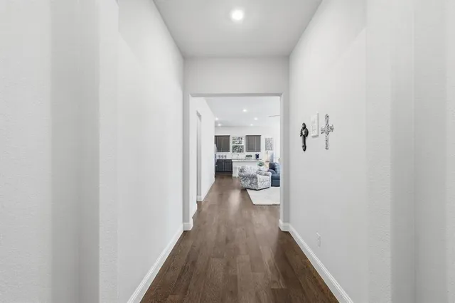 a view of a workspace with furniture and wooden floor