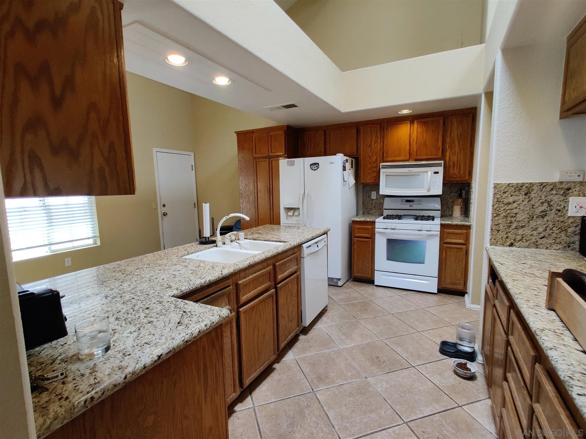 2934 Manzanita View Road Alpine, CA 91901 - Photo 9 of 12 a kitchen with stainless steel appliances granite countertop a sink stove and refrigerator