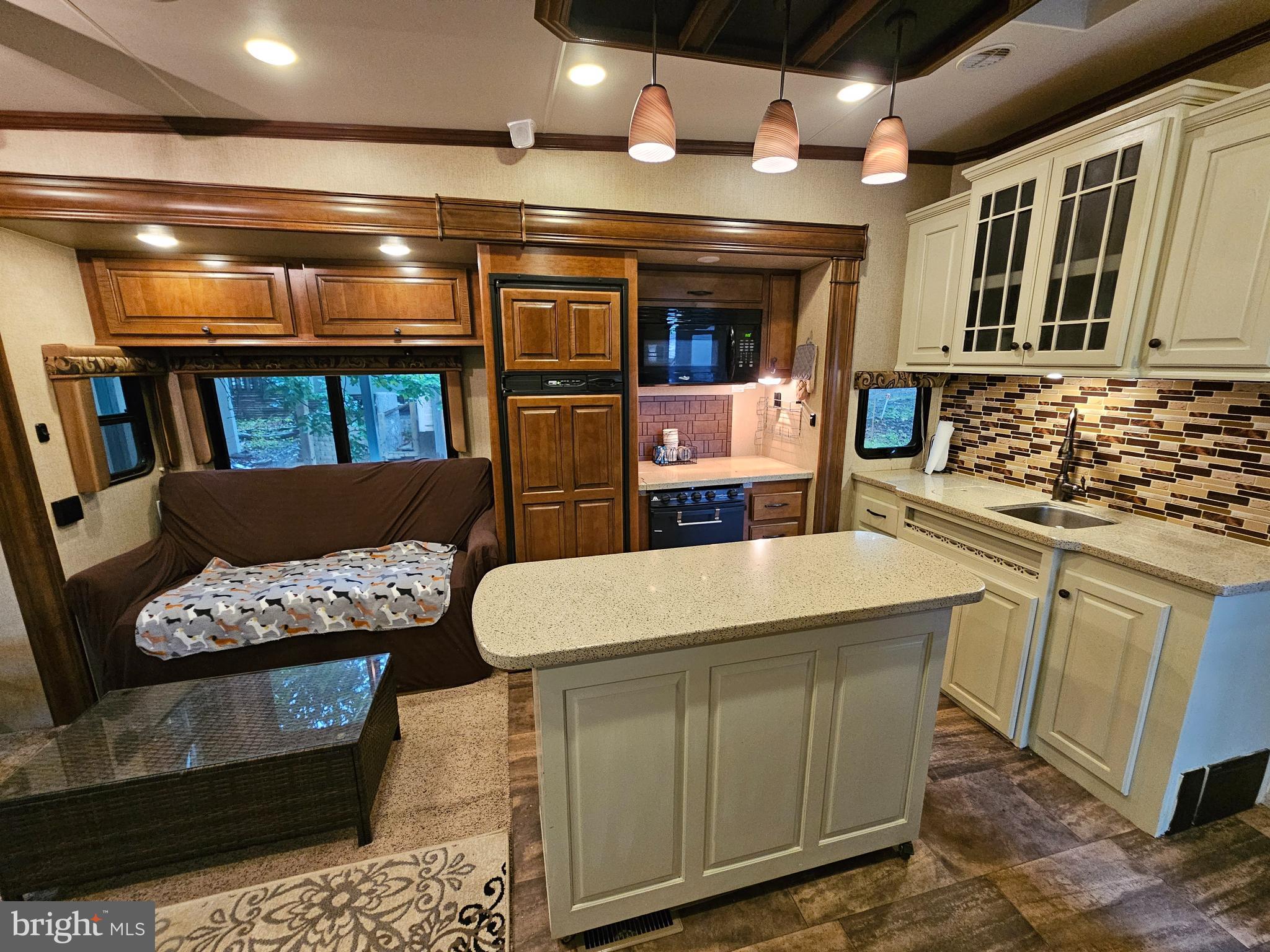 18 Hot Dog Road Falling Waters, WV 25419 - Photo 16 of 35 a kitchen with stainless steel appliances kitchen island granite countertop a sink and cabinets