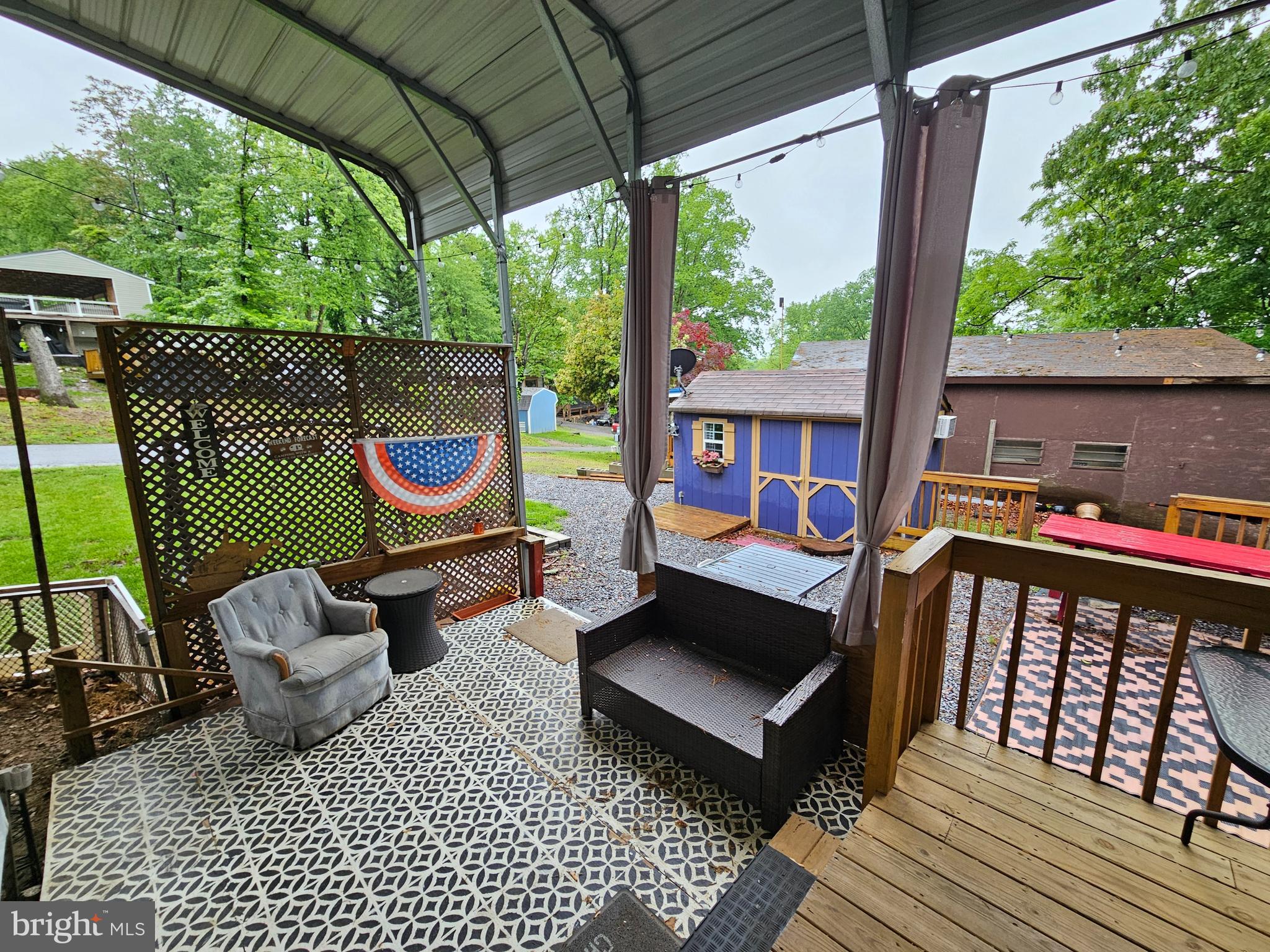 18 Hot Dog Road Falling Waters, WV 25419 - Photo 5 of 35 a view of a patio with a table chairs and a wooden deck