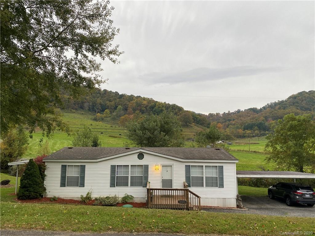 434 Dock Ratcliff Road Waynesville, NC 28786 - Photo 1 of 26 a front view of a house with a garden and yard
