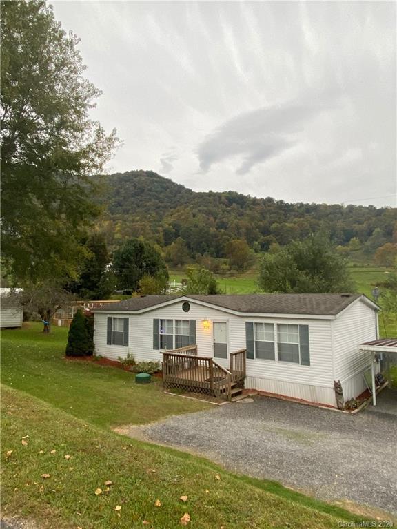 434 Dock Ratcliff Road Waynesville, NC 28786 - Photo 2 of 26 a front view of a house with a garden and trees