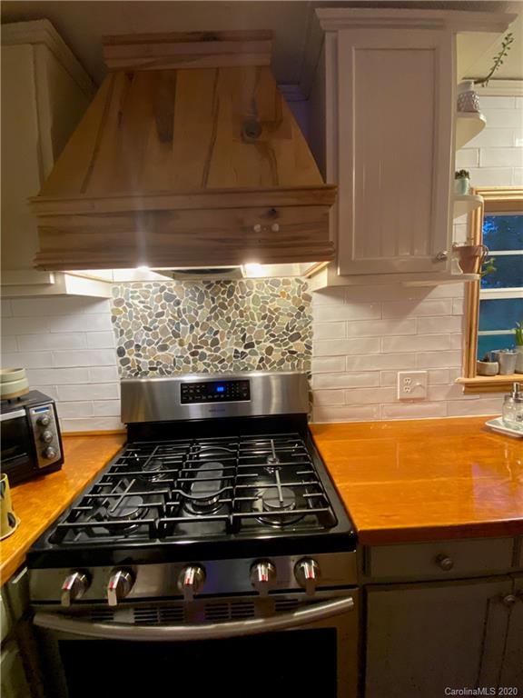 434 Dock Ratcliff Road Waynesville, NC 28786 - Photo 15 of 26 a stove top oven sitting inside of a kitchen