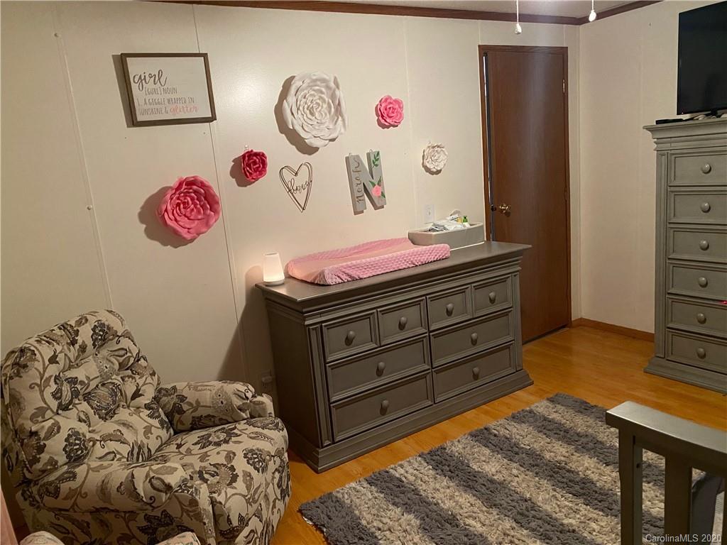 434 Dock Ratcliff Road Waynesville, NC 28786 - Photo 20 of 26 a bedroom with a bed and a dresser