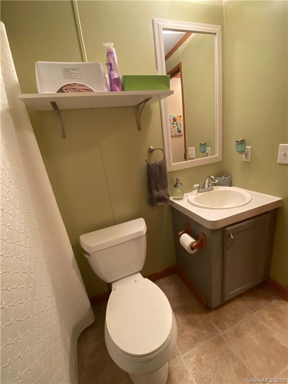 434 Dock Ratcliff Road Waynesville, NC 28786 - Photo 21 of 26 a bathroom with a toilet sink and mirror