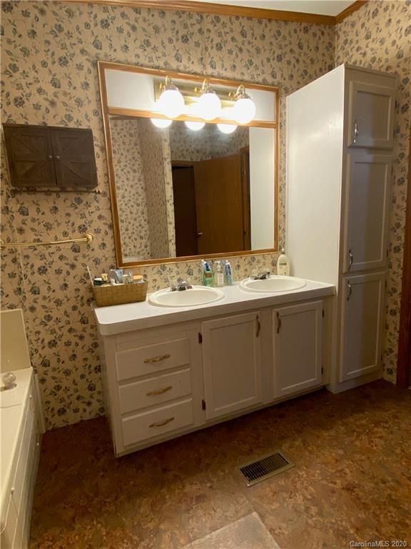 434 Dock Ratcliff Road Waynesville, NC 28786 - Photo 26 of 26 a bathroom with a sink a mirror and a shower