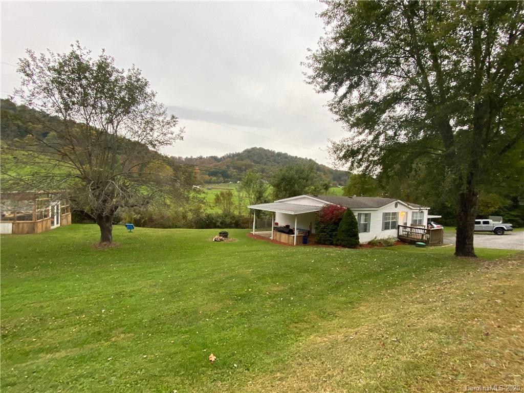 434 Dock Ratcliff Road Waynesville, NC 28786 - Photo 5 of 26 a view of a house with a big yard and large trees