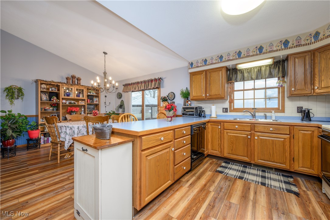 893 Industry Road Atwater, OH 44201 - Photo 16 of 50 Kitchen with kitchen peninsula, sink, pendant lighting, dishwasher, and lofted ceiling
