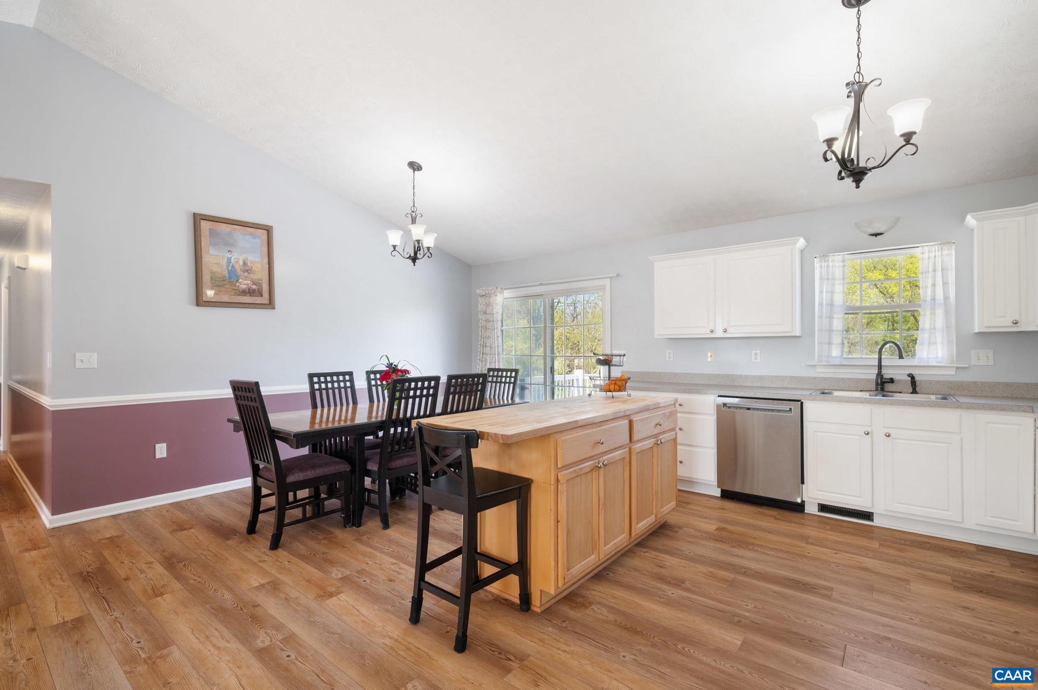 225 Mayfield La Waynesboro, VA 22980 - Photo 5 of 56 a kitchen with a dining table chairs and white cabinets