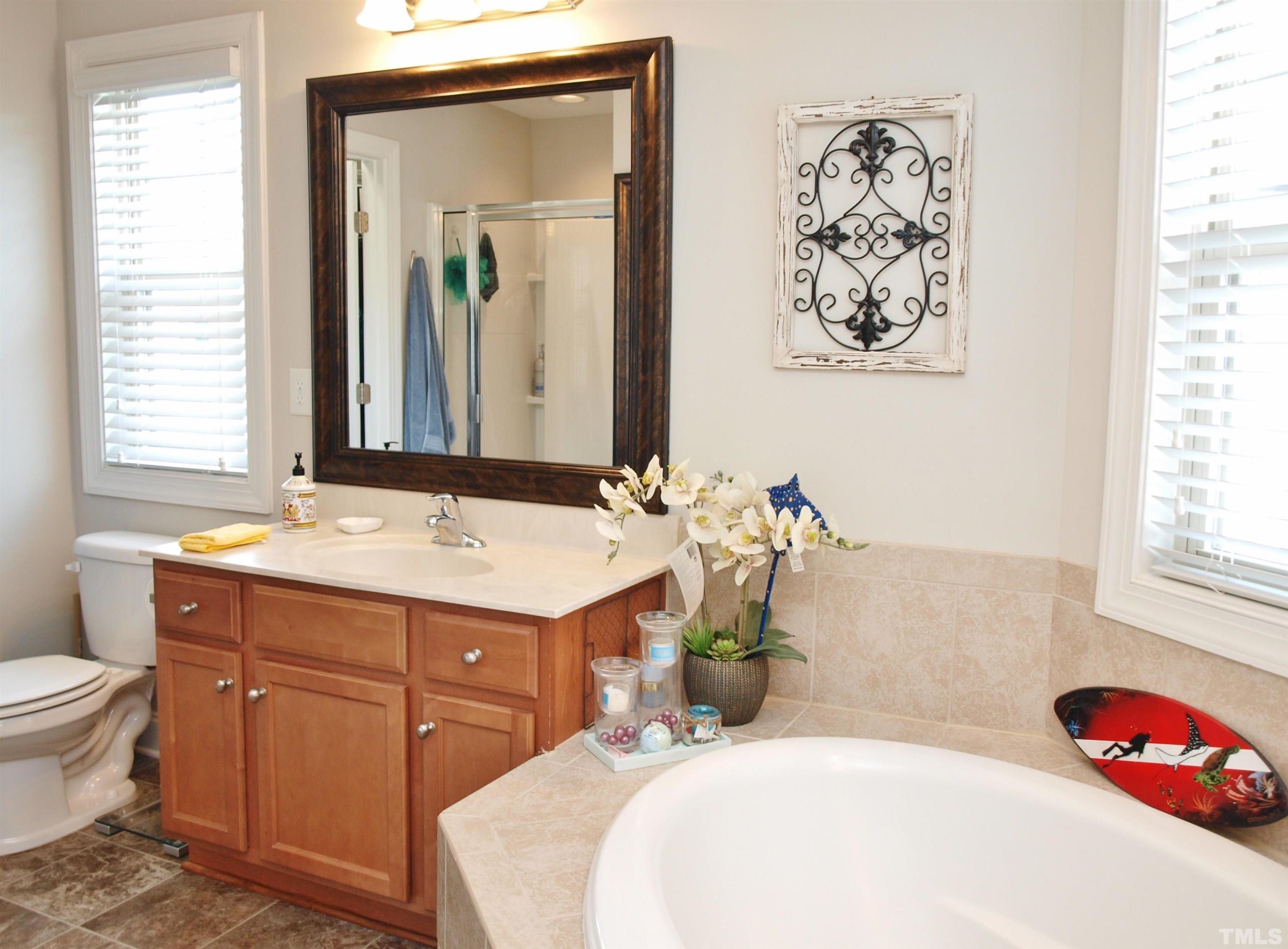 7613 Weathered Oak Way Raleigh, NC 27616 - Photo 12 of 22 Separate garden tub and shower in the primary bathroom.