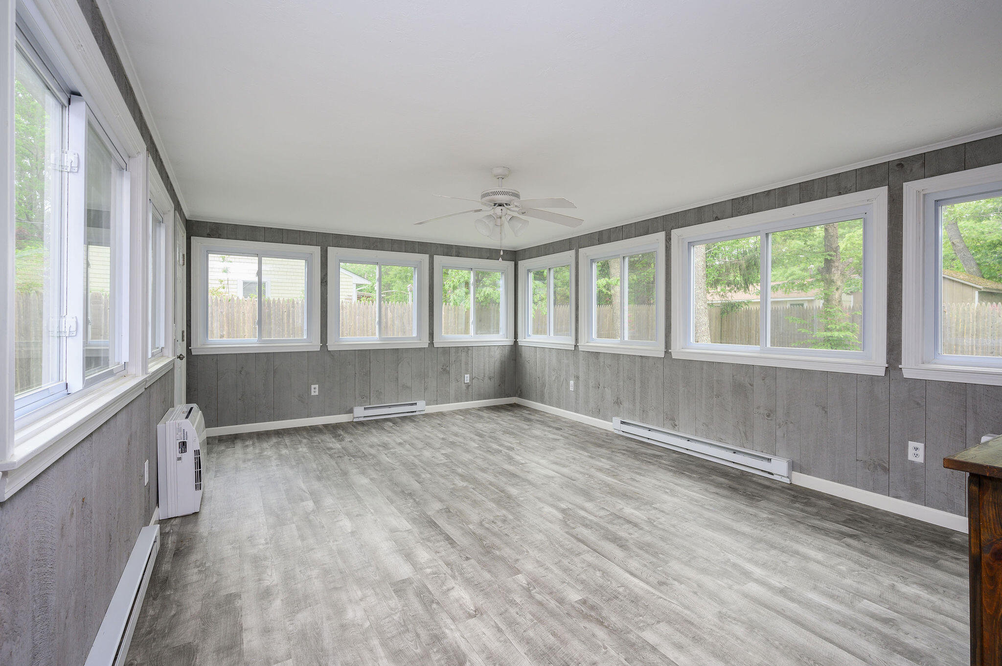 54 Beechwood Drive Mashpee, MA 02649 - Photo 12 of 34 an empty room with wooden floor and windows