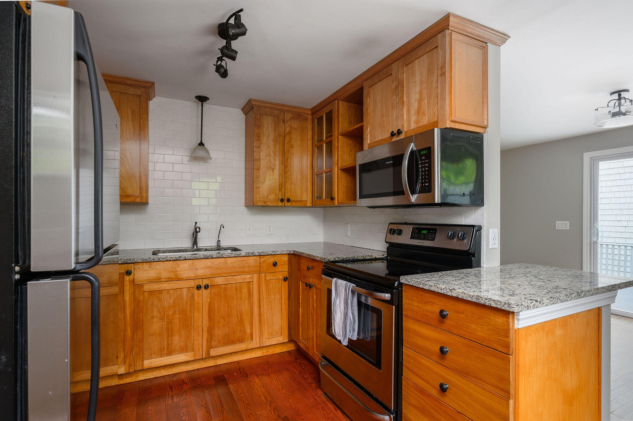 54 Beechwood Drive Mashpee, MA 02649 - Photo 16 of 34 a kitchen with stainless steel appliances granite countertop a sink stove and microwave