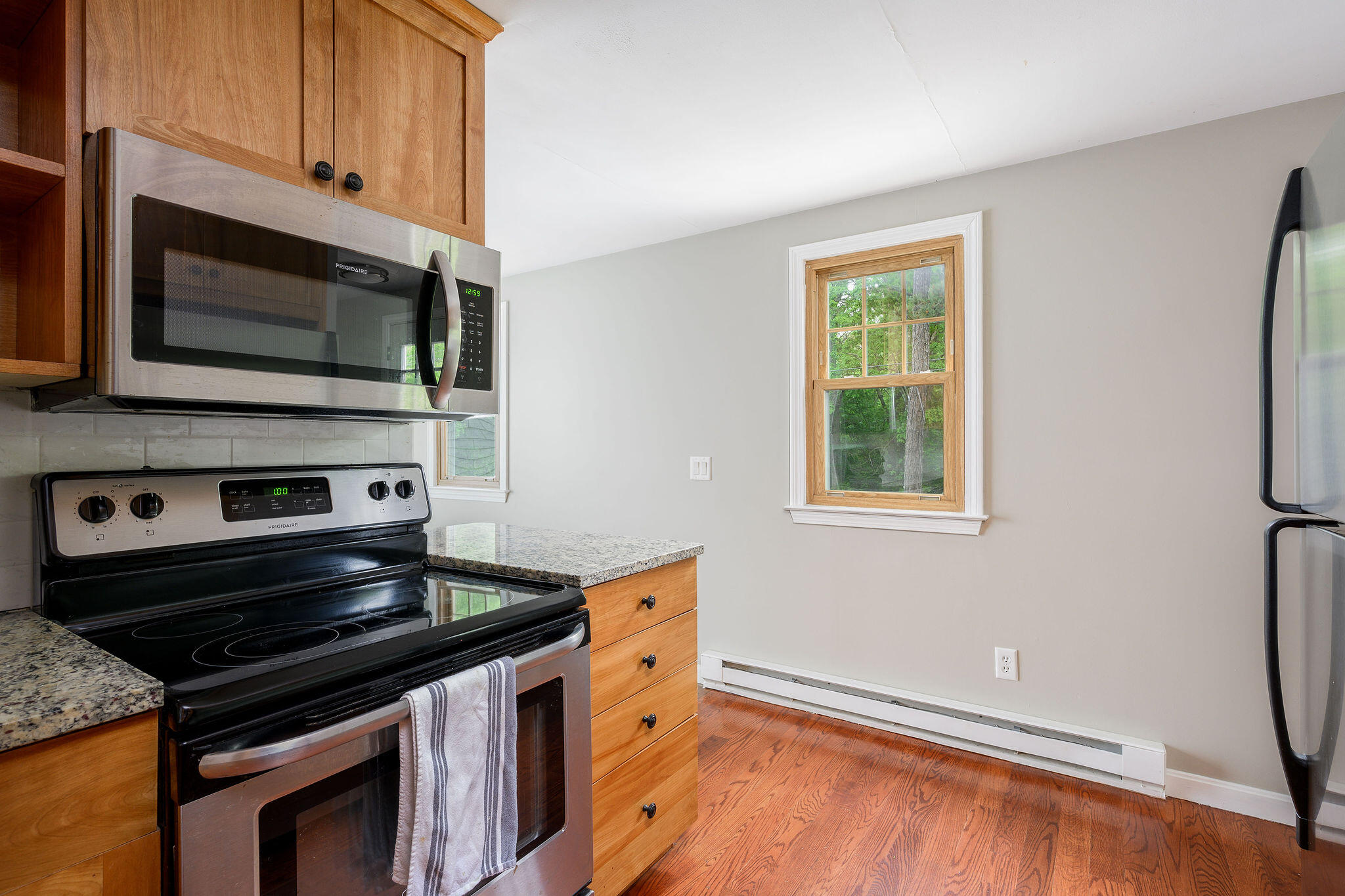 54 Beechwood Drive Mashpee, MA 02649 - Photo 17 of 34 a kitchen with a stove and a microwave