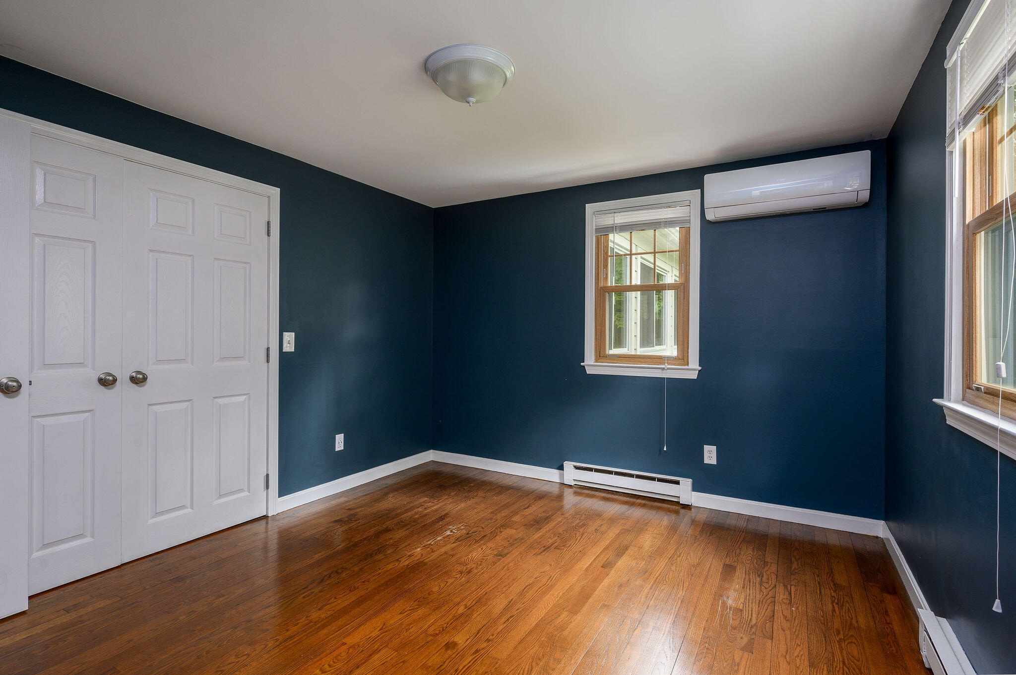 54 Beechwood Drive Mashpee, MA 02649 - Photo 21 of 34 an empty room with wooden floor and windows