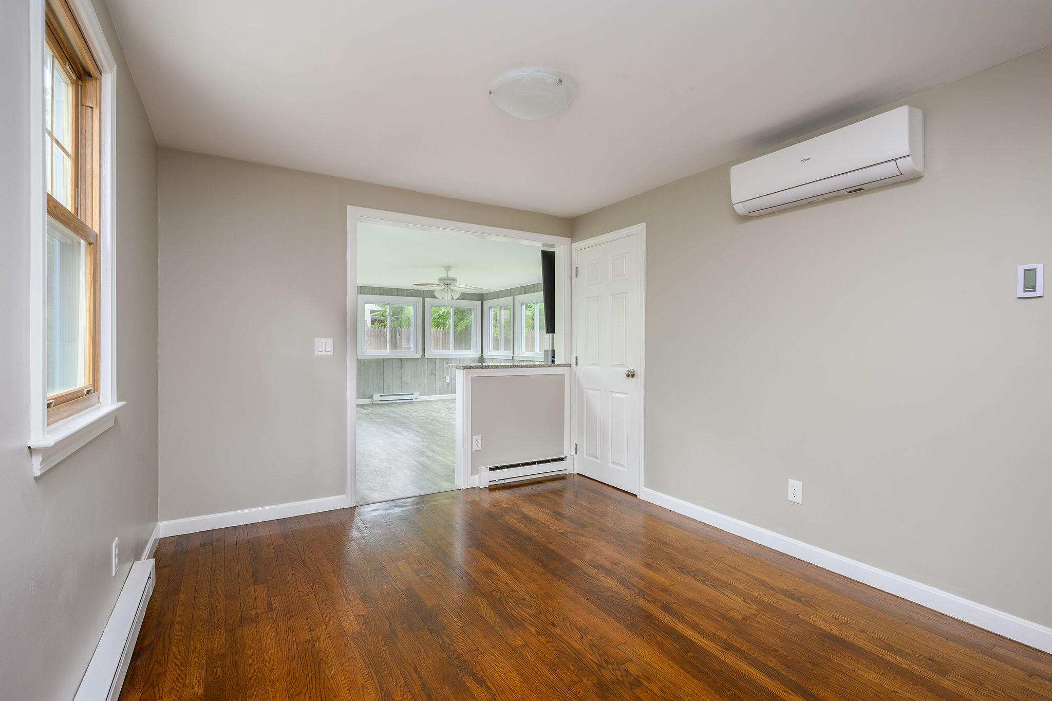 54 Beechwood Drive Mashpee, MA 02649 - Photo 24 of 34 an empty room with wooden floor and windows