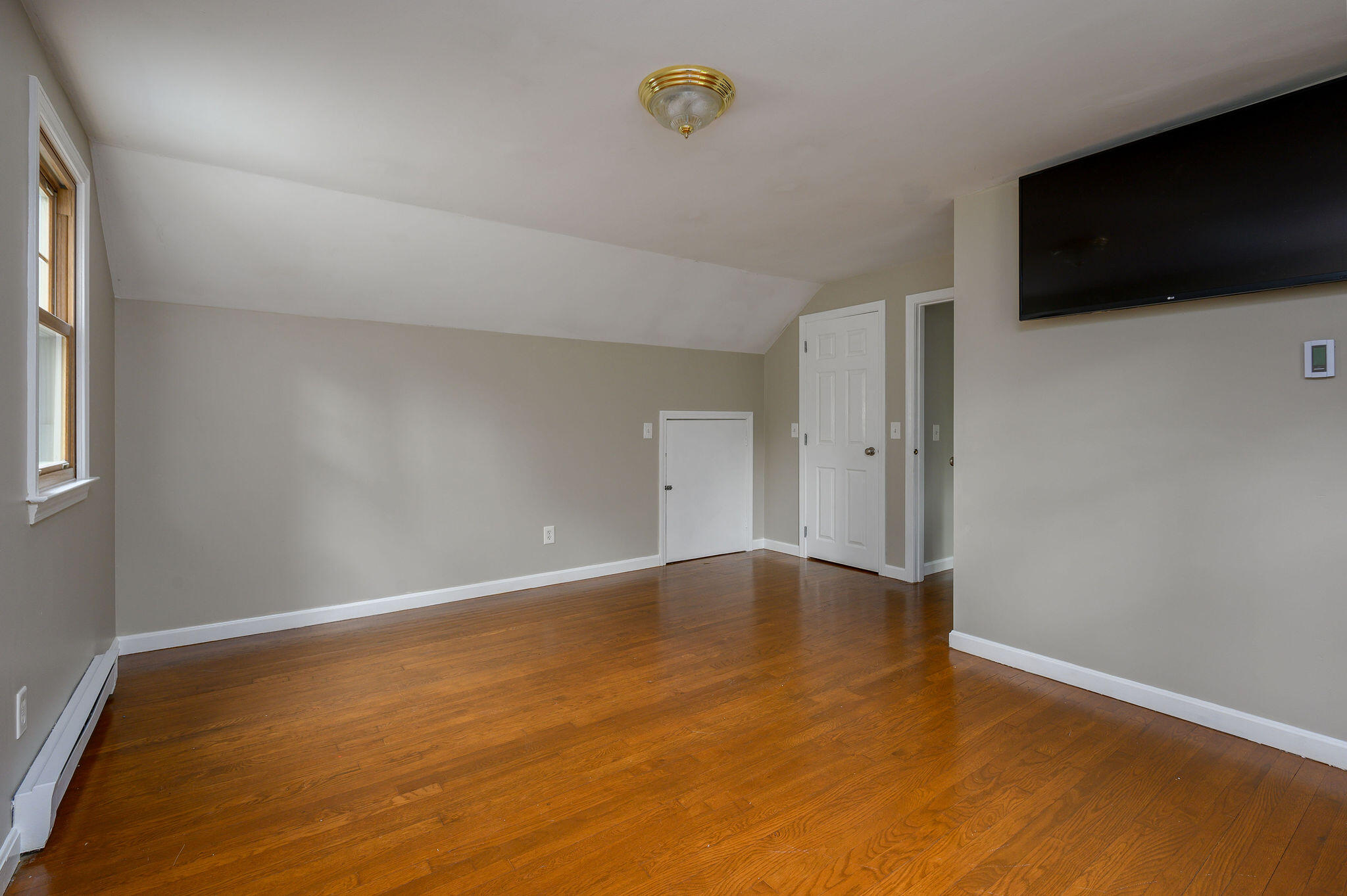 54 Beechwood Drive Mashpee, MA 02649 - Photo 28 of 34 a view of an empty room with wooden floor and a window