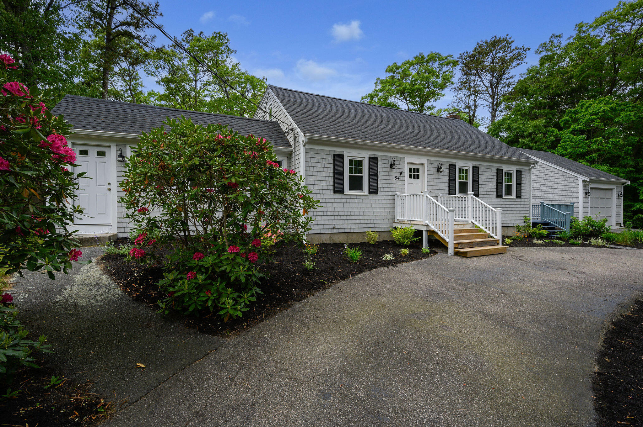 54 Beechwood Drive Mashpee, MA 02649 - Photo 32 of 34 a front view of a house with a garden