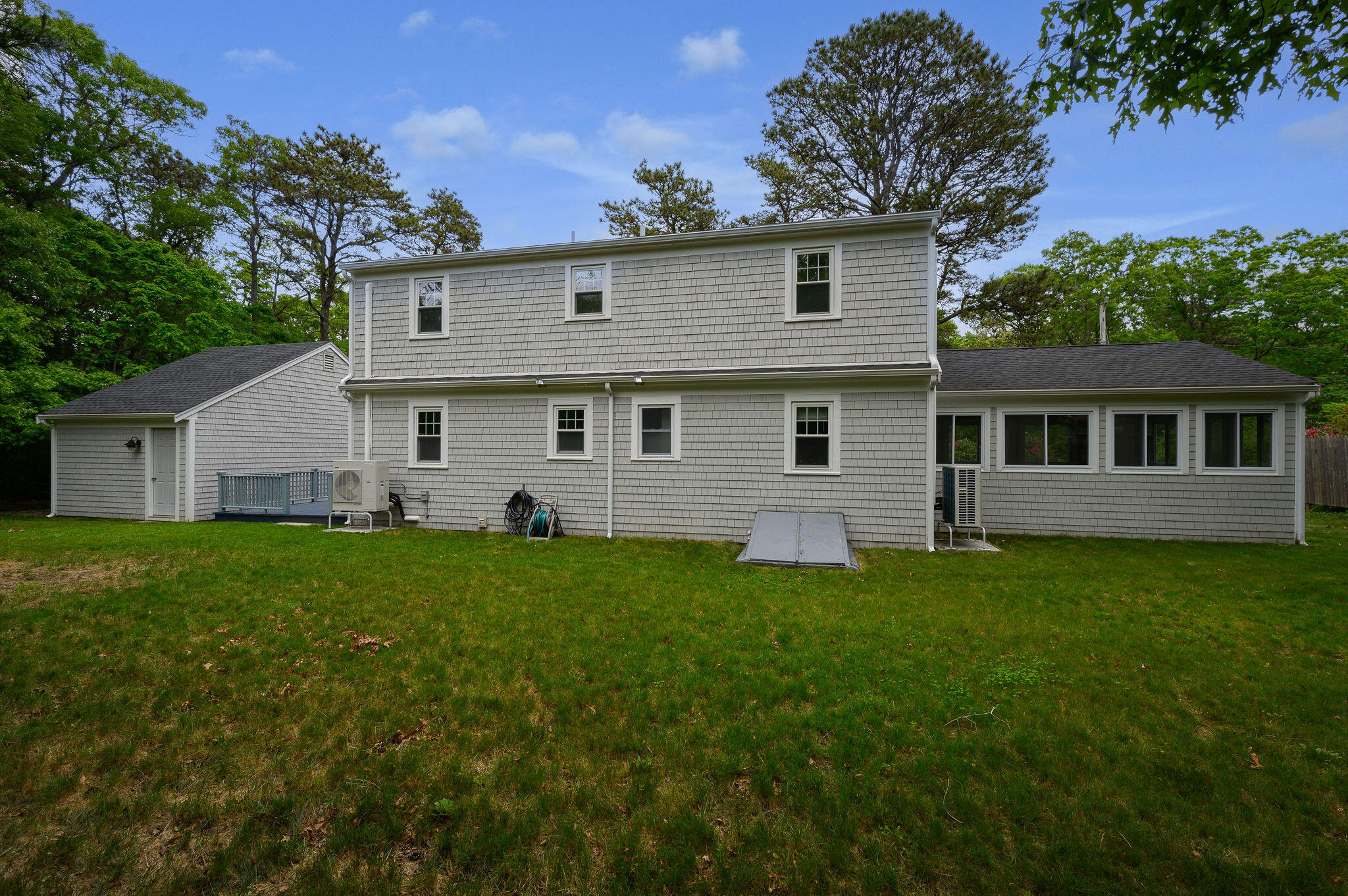 54 Beechwood Drive Mashpee, MA 02649 - Photo 4 of 34 a view of a yard in front of a house with large trees