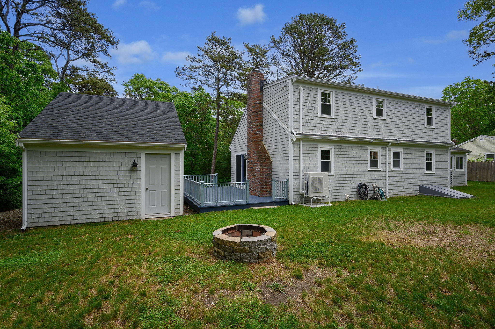 54 Beechwood Drive Mashpee, MA 02649 - Photo 5 of 34 a view of a house with a backyard