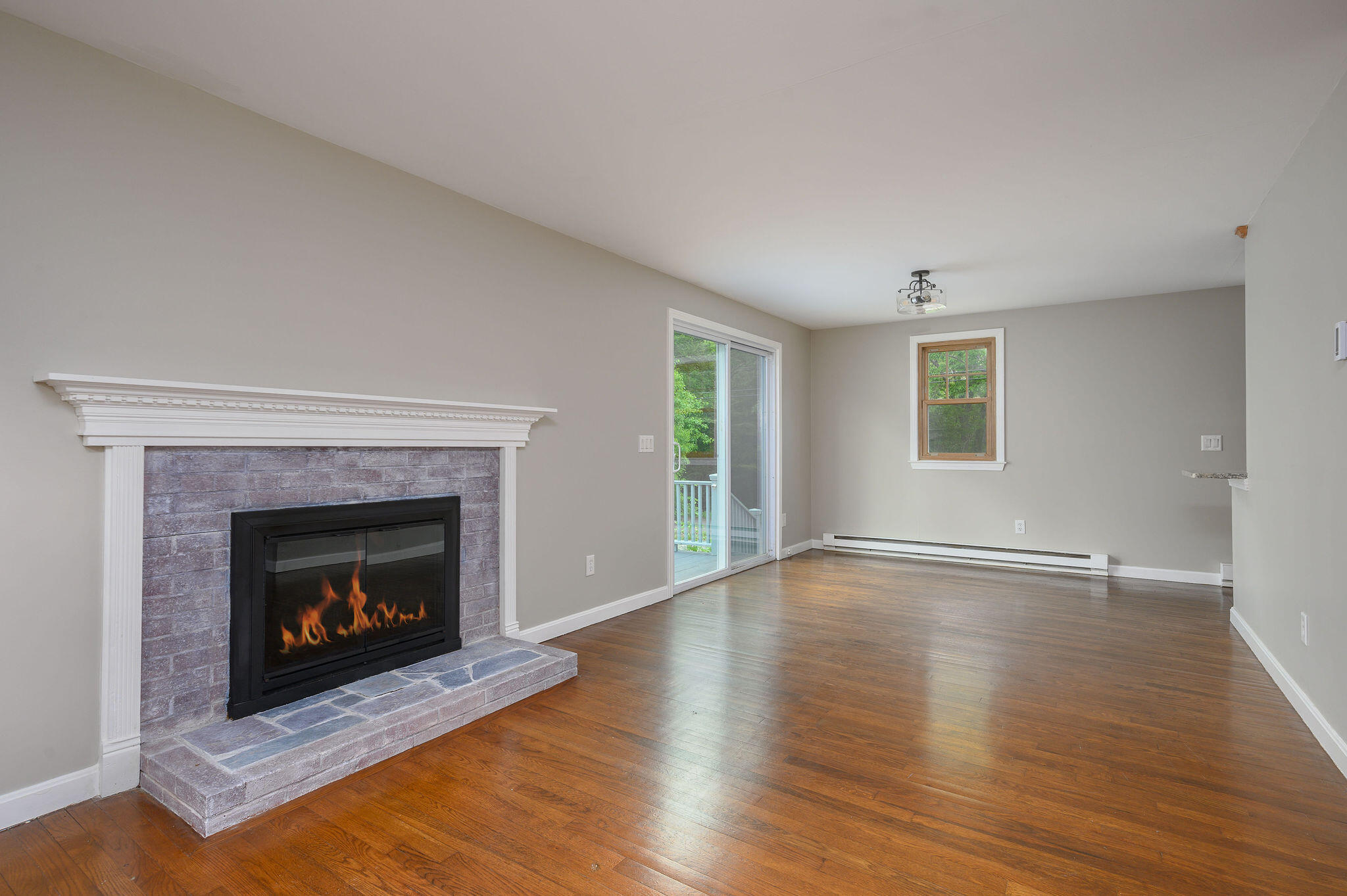 54 Beechwood Drive Mashpee, MA 02649 - Photo 8 of 34 a living room with wooden floor and a fireplace