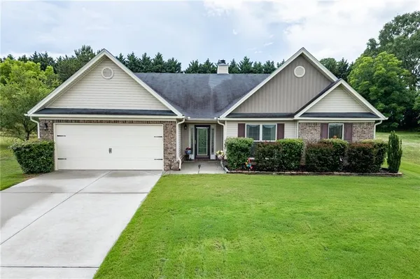 a front view of a house with yard
