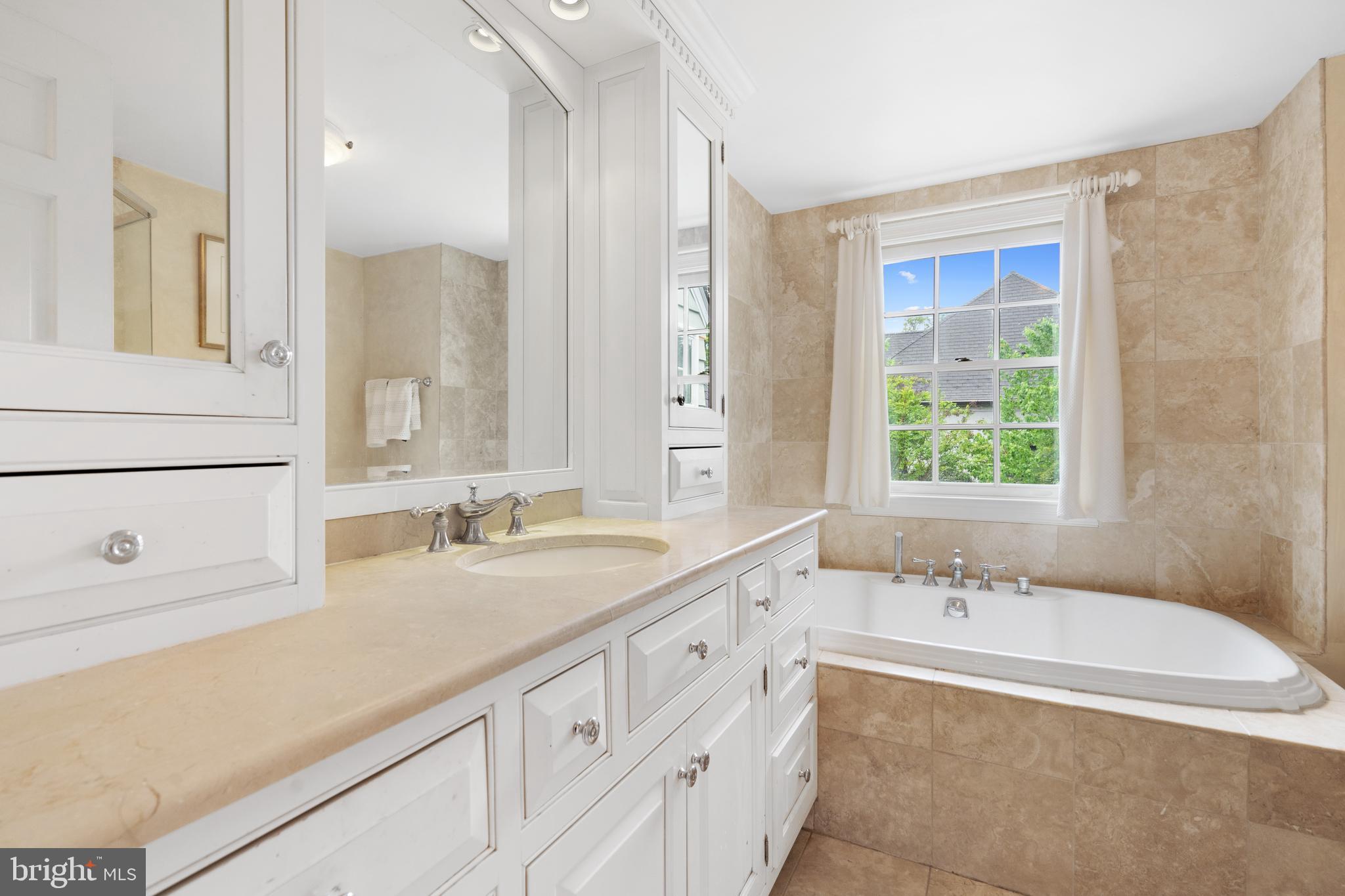 6511 Ridge Street McLean, VA 22101 - Photo 15 of 17 a bathroom with a tub sink and mirror
