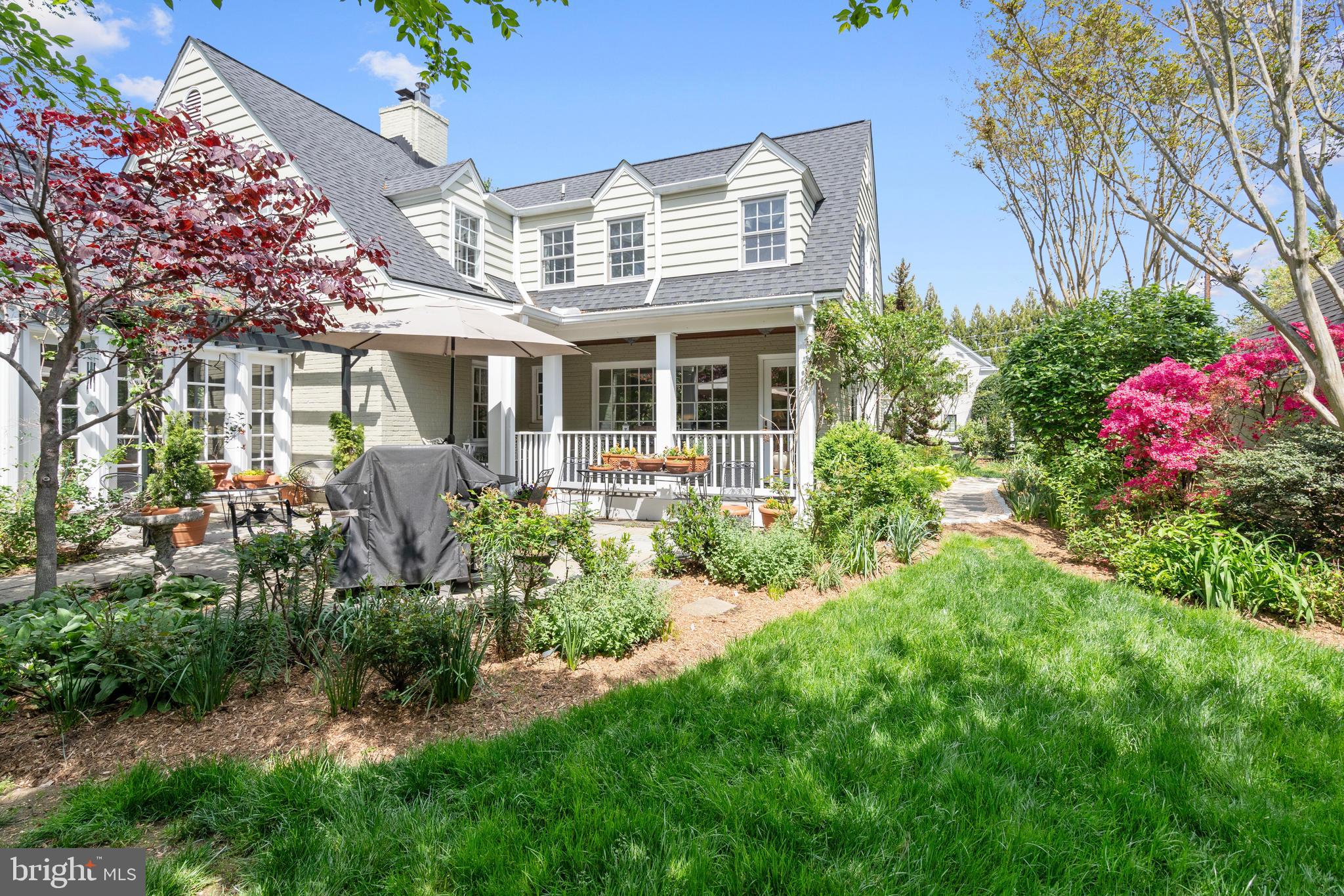 6511 Ridge Street McLean, VA 22101 - Photo 5 of 17 a front view of a house with a yard and fountain in middle