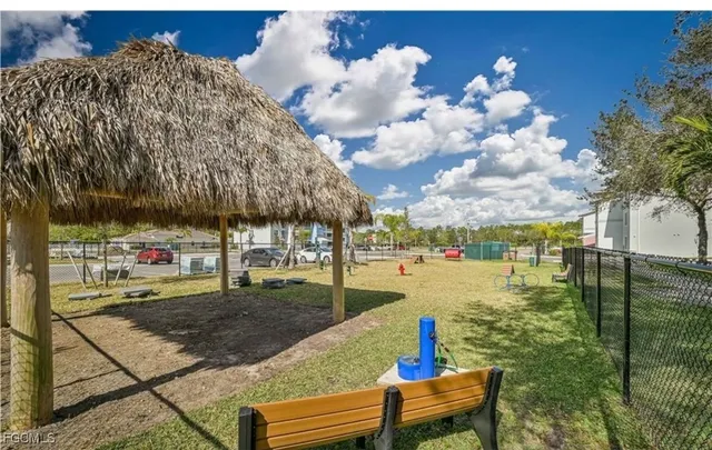 a roof deck with table and chairs and potted plants