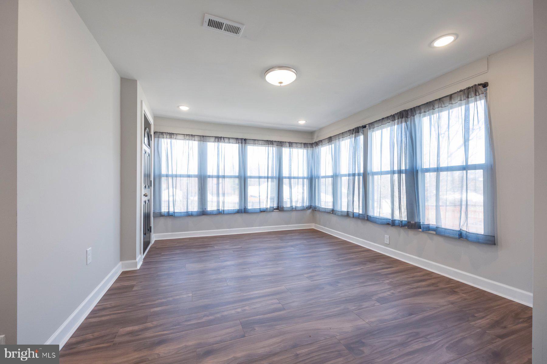 7508 Brightside Avenue Rosedale, MD 21237 - Photo 9 of 27 wooden floor in an empty room with a window