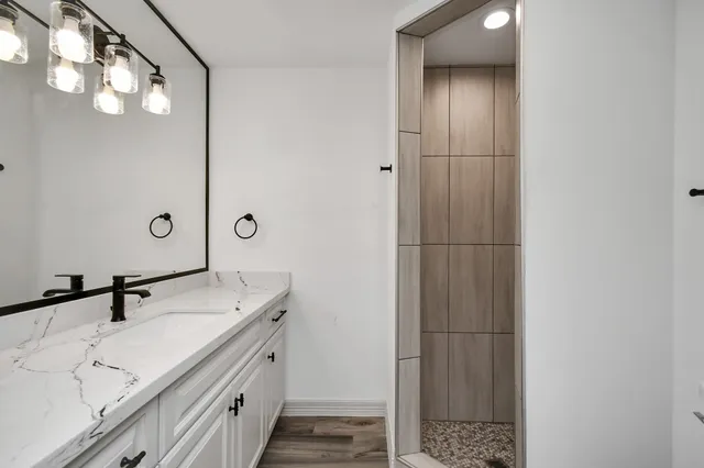 a spacious bathroom with a double vanity sink and mirror