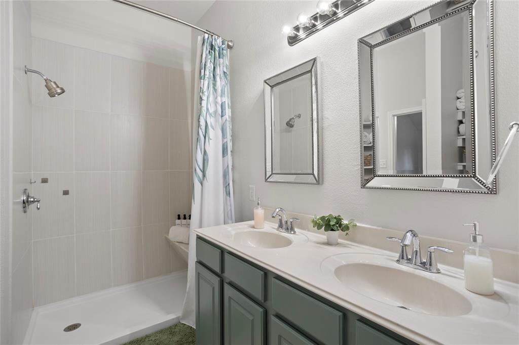 213 Arabian Road Waxahachie, TX 75165 - Photo 15 of 29 Bathroom featuring double vanity and a shower stall
