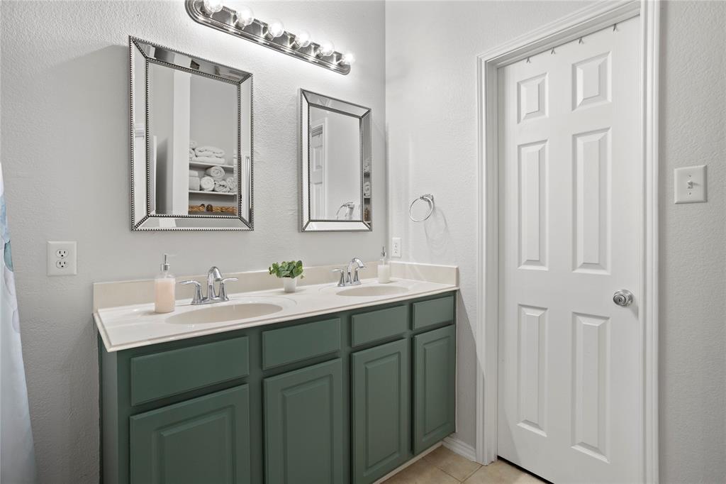 213 Arabian Road Waxahachie, TX 75165 - Photo 16 of 29 Bathroom with a textured wall and double vanity
