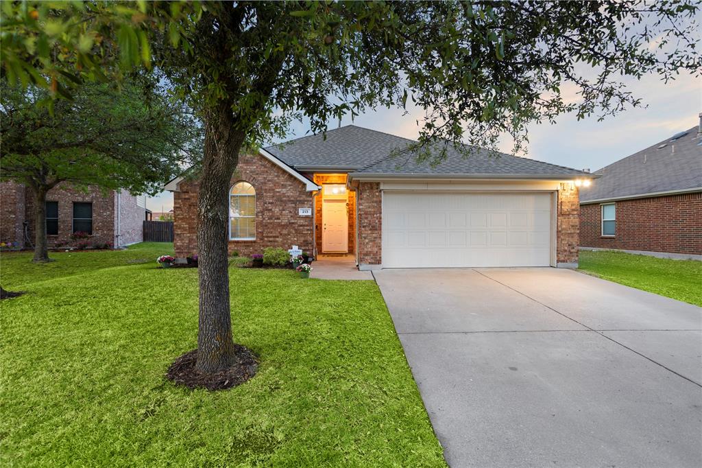 213 Arabian Road Waxahachie, TX 75165 - Photo 3 of 29 Single story home with brick siding, driveway, a garage, and a lawn