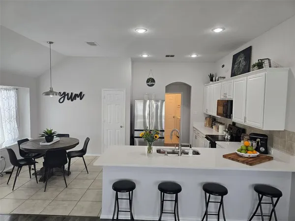 a kitchen with cabinets appliances a sink and a counter top space