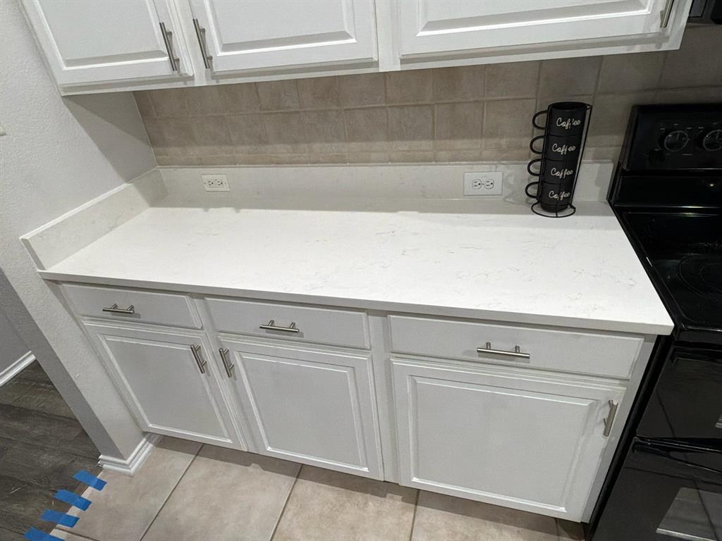 213 Arabian Road Waxahachie, TX 75165 - Photo 9 of 29 Detailed view of white cabinetry and black / electric stove