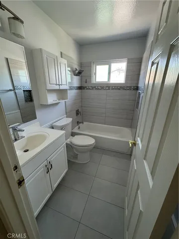 a bathroom with a double vanity sink toilet and shower