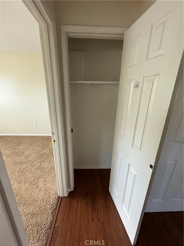 a view of a hallway view with wooden floor and staircase