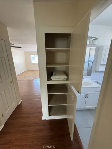 a view of walk in closet with empty racks
