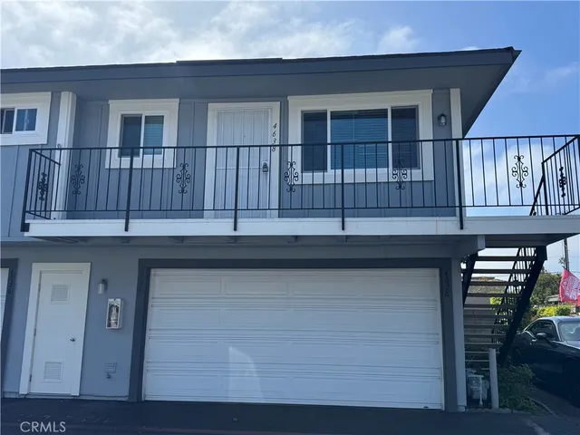 a kitchen with a white wall and cabinets