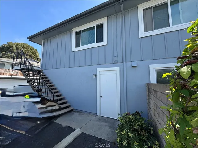 a house with potted plants in front of door