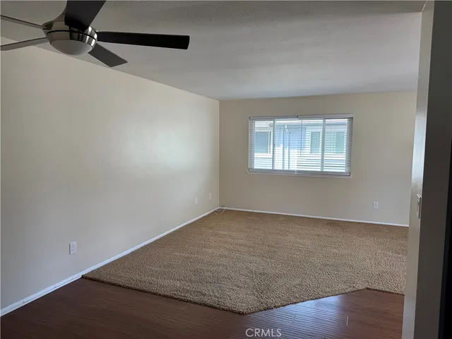 an empty room with a empty space and windows