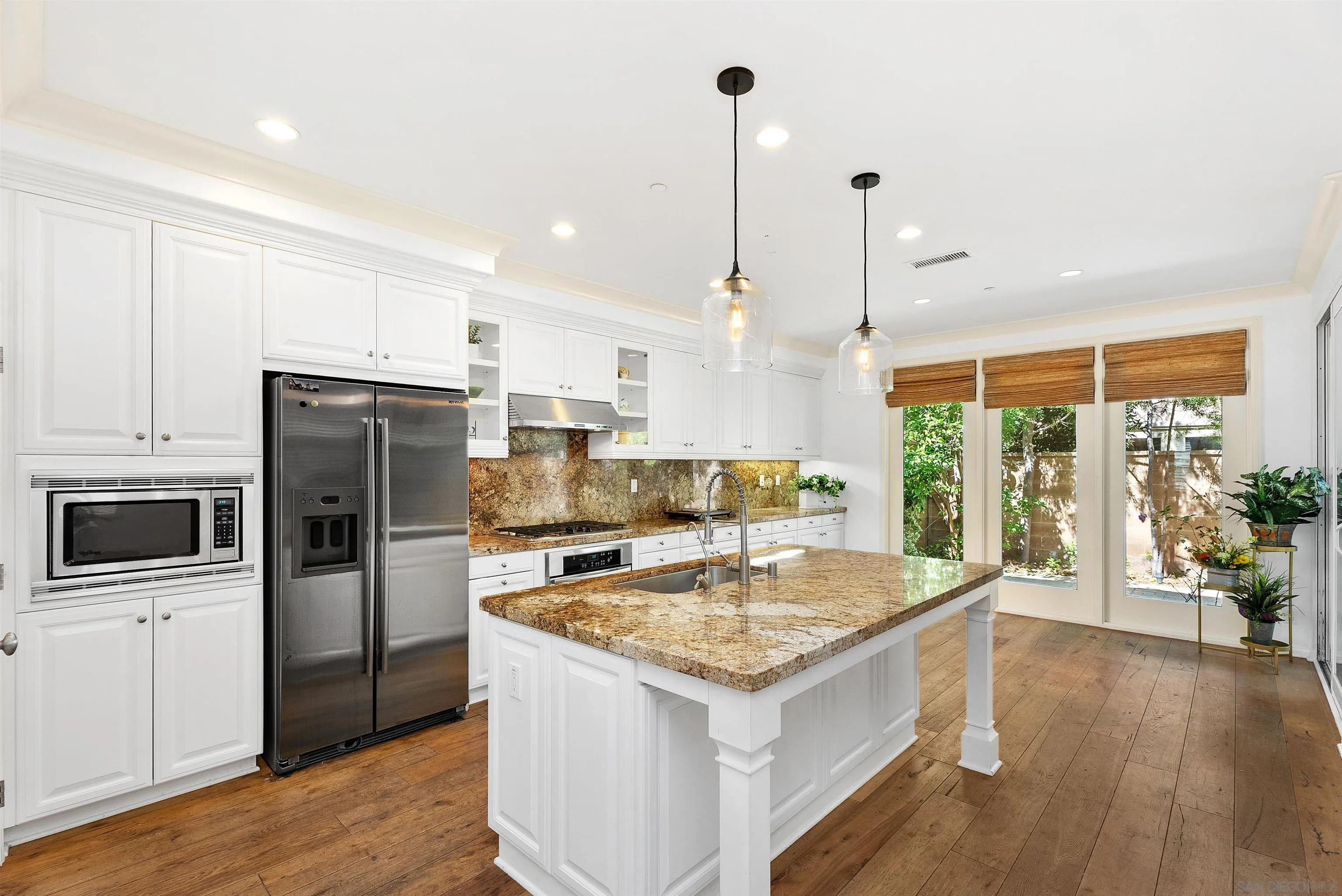 55 Diamond Irvine, CA 92620 - Photo 7 of 30 a kitchen with a refrigerator a sink and wooden floor
