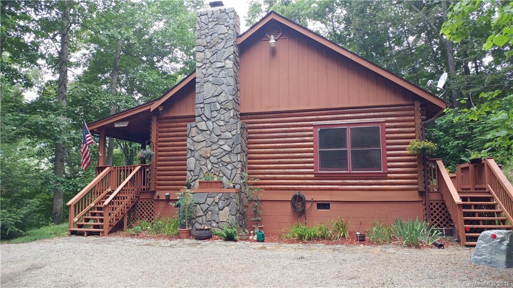 127 Dolan Lane, Unit 8338 Clyde, NC 28721 - Photo 1 of 21 a backyard of a house with plants and trees