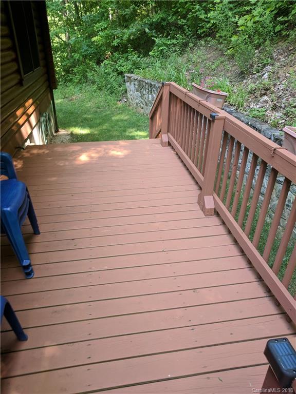 127 Dolan Lane, Unit 8338 Clyde, NC 28721 - Photo 2 of 21 a view of deck with wooden floor and fence and trees around