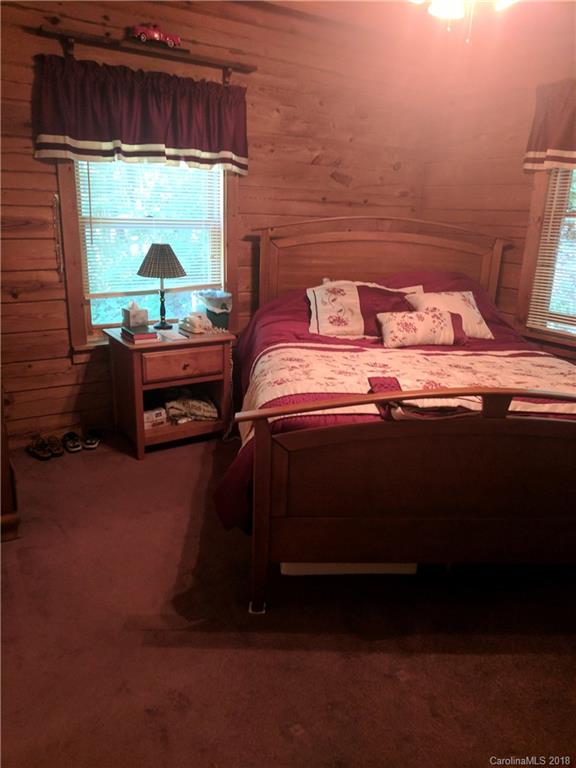 127 Dolan Lane, Unit 8338 Clyde, NC 28721 - Photo 8 of 21 a bedroom with a bed and a window