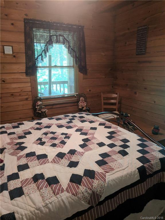 127 Dolan Lane, Unit 8338 Clyde, NC 28721 - Photo 9 of 21 a bedroom with a bed and a window