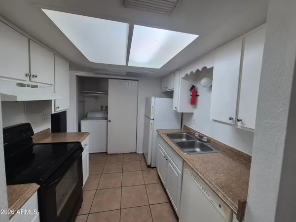a kitchen with cabinets and window